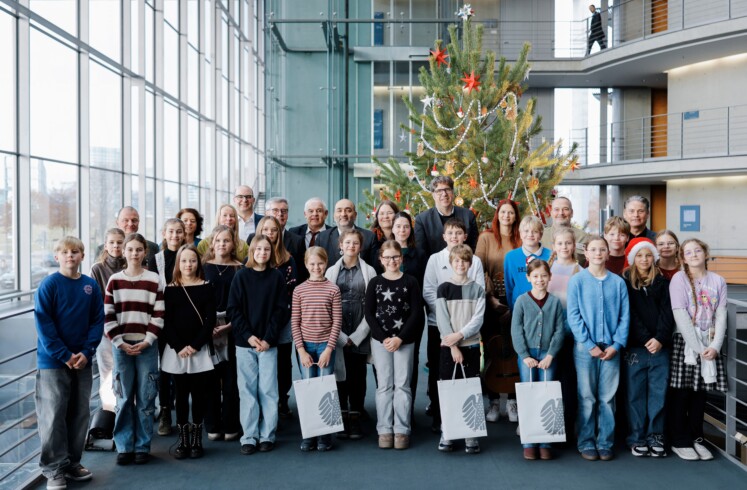 Bundestagsvizepräsident Omid Nouripour, Bündnis 90/Die Grünen, MdB, nimmt den Weihnachtsbaum des Naturparks Barnim entgegen. Gruppenfoto mit den Kindern der Naturpark-Schule Schönow vor dem Weihnachtsbaum. © Deutscher Bundestag / Anika Nowak